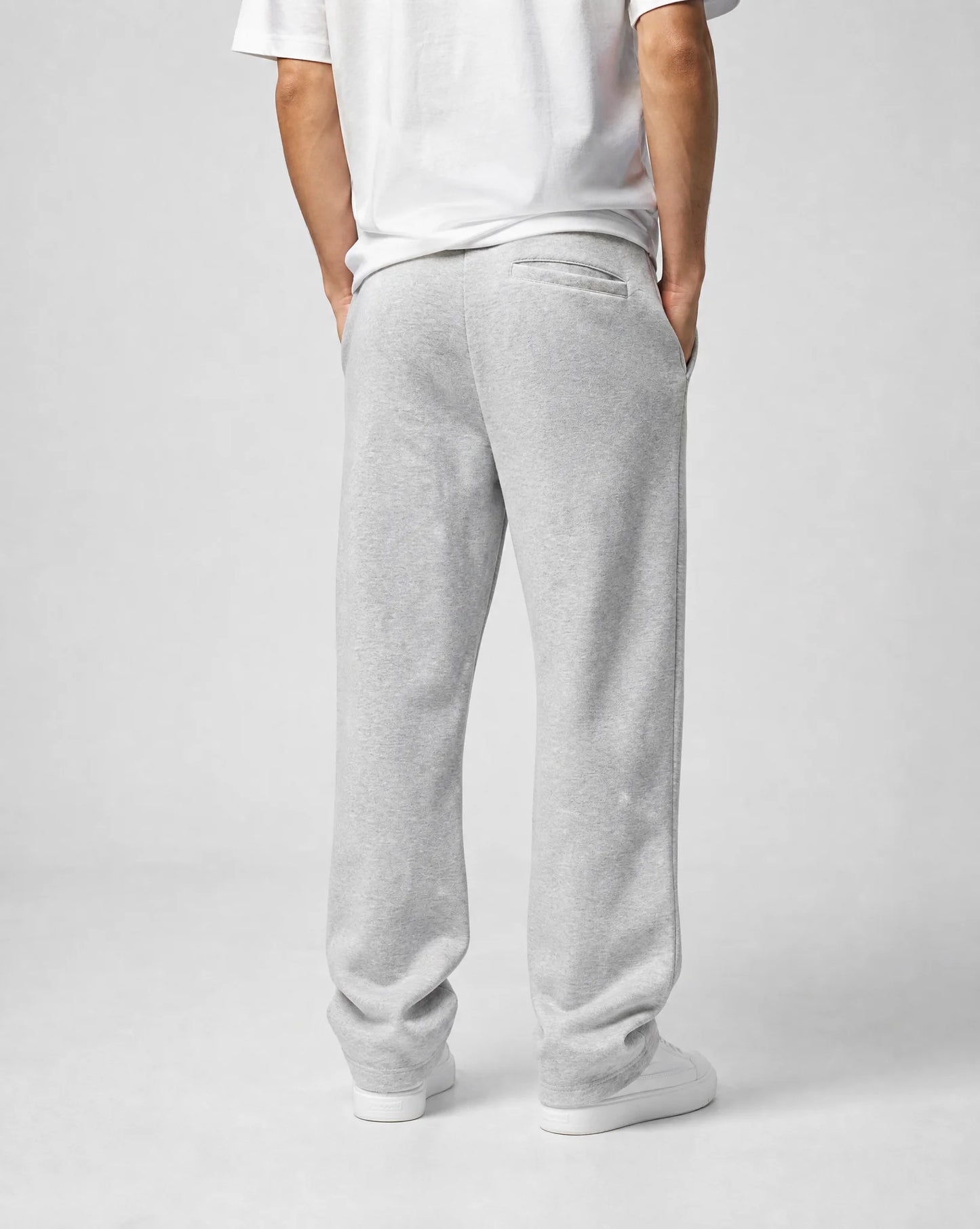 Back view of men's grey relaxed fit open hem joggers featuring a straight leg silhouette and premium fleece fabric by ILYNORA