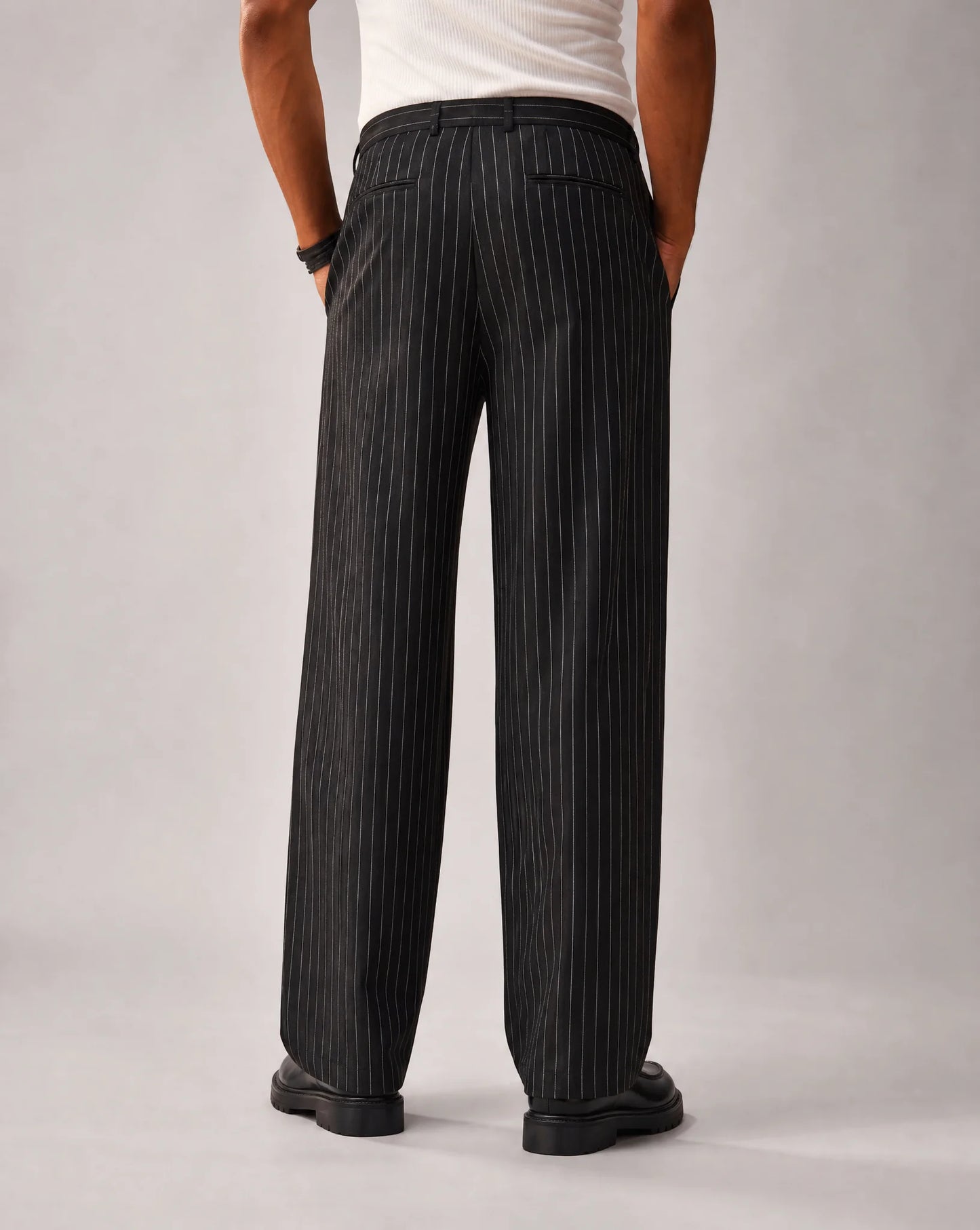 Men's black pinstripe wide leg trousers with relaxed drape and versatile everyday style by ILYNORA
