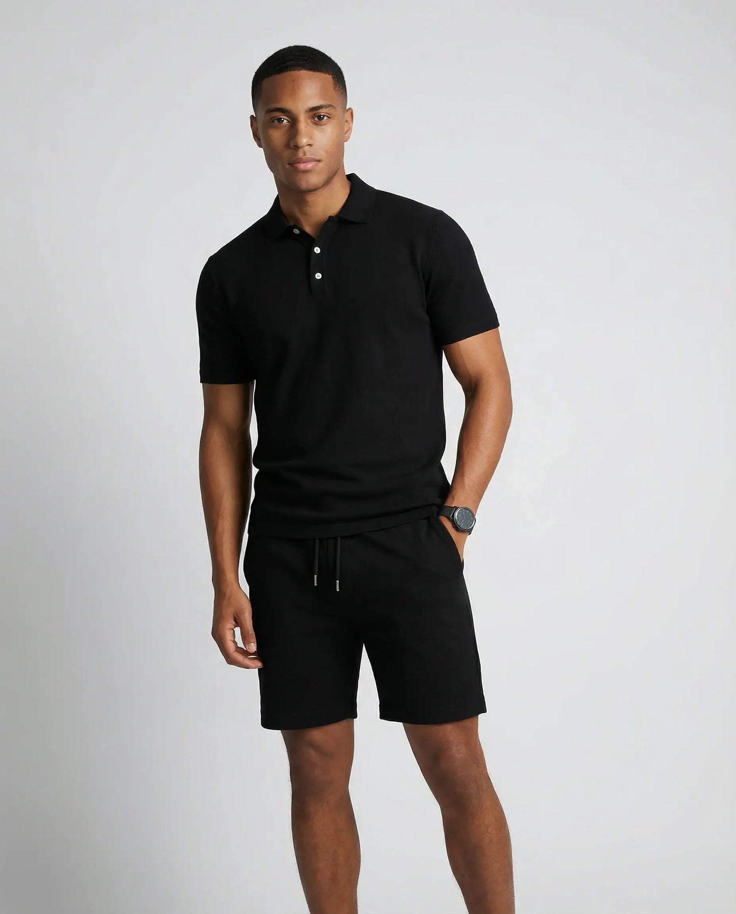 Men's polo shirt and shorts set in black by Ilynora, front view with minimal design and relaxed fit