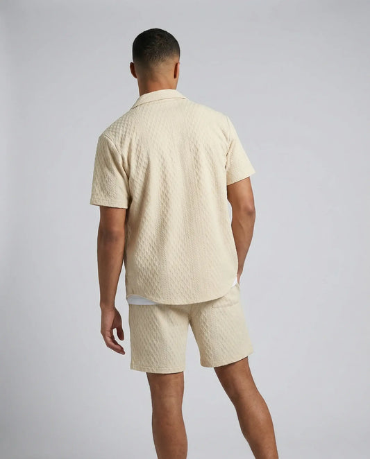 Khaki textured shirt and shorts set by Ilynora, back view highlighting matching set and clean silhouette