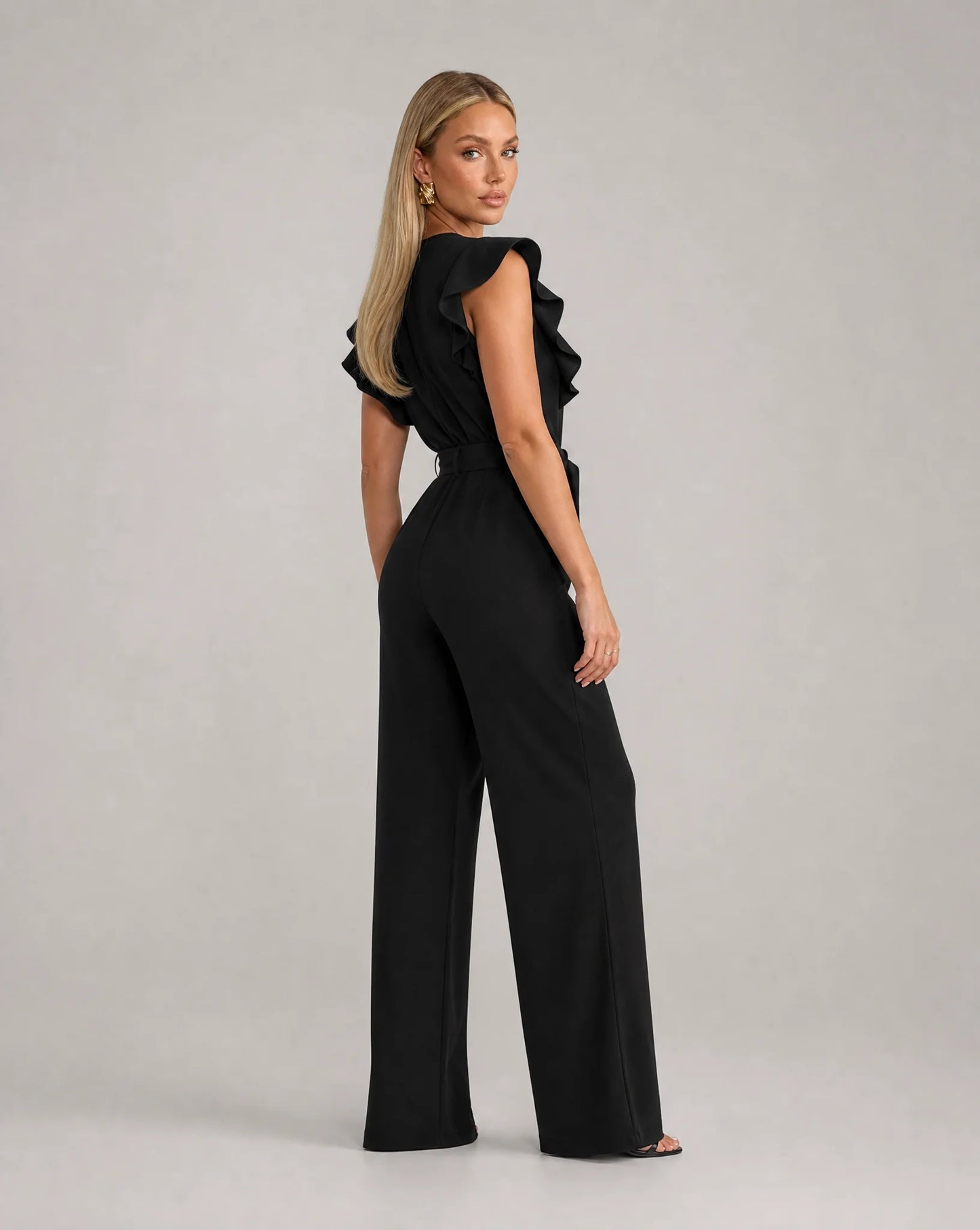 Black ruffle sleeve jumpsuit for women by Ilynora, back view showcasing the elegant fit and flowing design