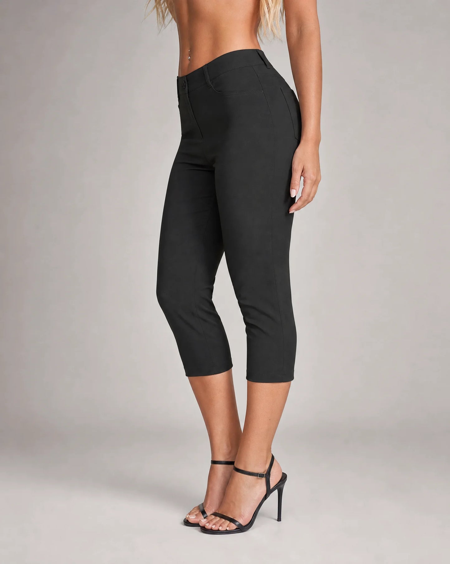 Women's black cropped stretch capri pants with flattering regular fit, side pockets and flexible fabric by ILYNORA