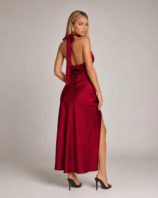 Red halterneck satin maxi dress for women by Ilynora, full length view highlighting the fluid fit and leg split