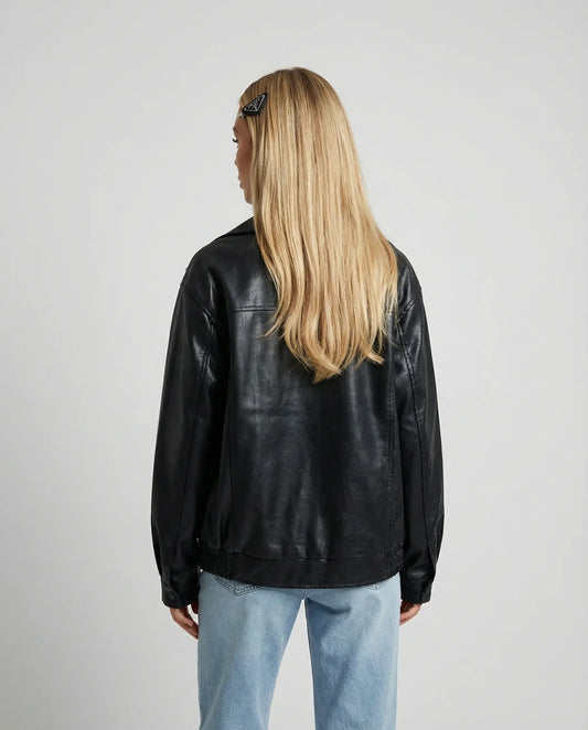Black oversized leather jacket by Ilynora, back view highlighting clean design and modern shape