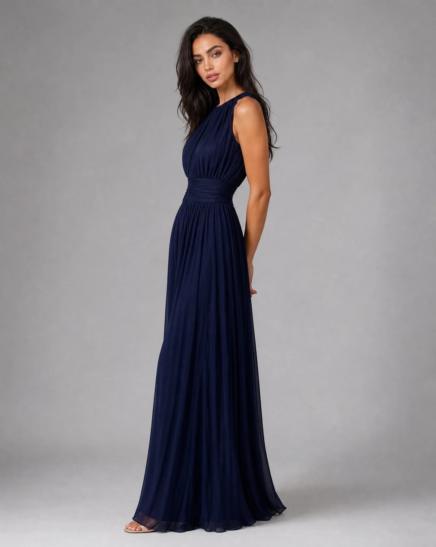Women's navy blue chiffon maxi dress with sleeveless design and flowing formal occasion look by ILYNORA