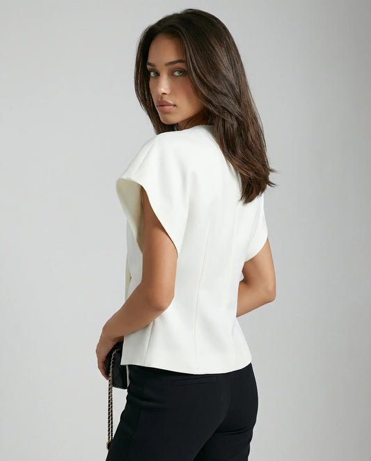 White blouse by Ilynora, side/back view with fluid shape and structured fit