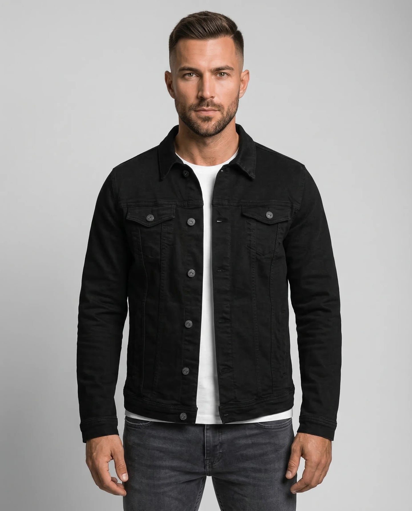 Black classic trucker denim jacket for men by Ilynora, front view with button closure and chest pockets