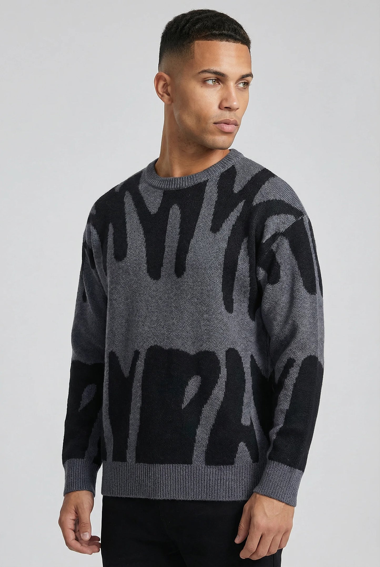 Grey abstract jacquard knit crew neck jumper for men by Ilynora London, side view with modern relaxed fit