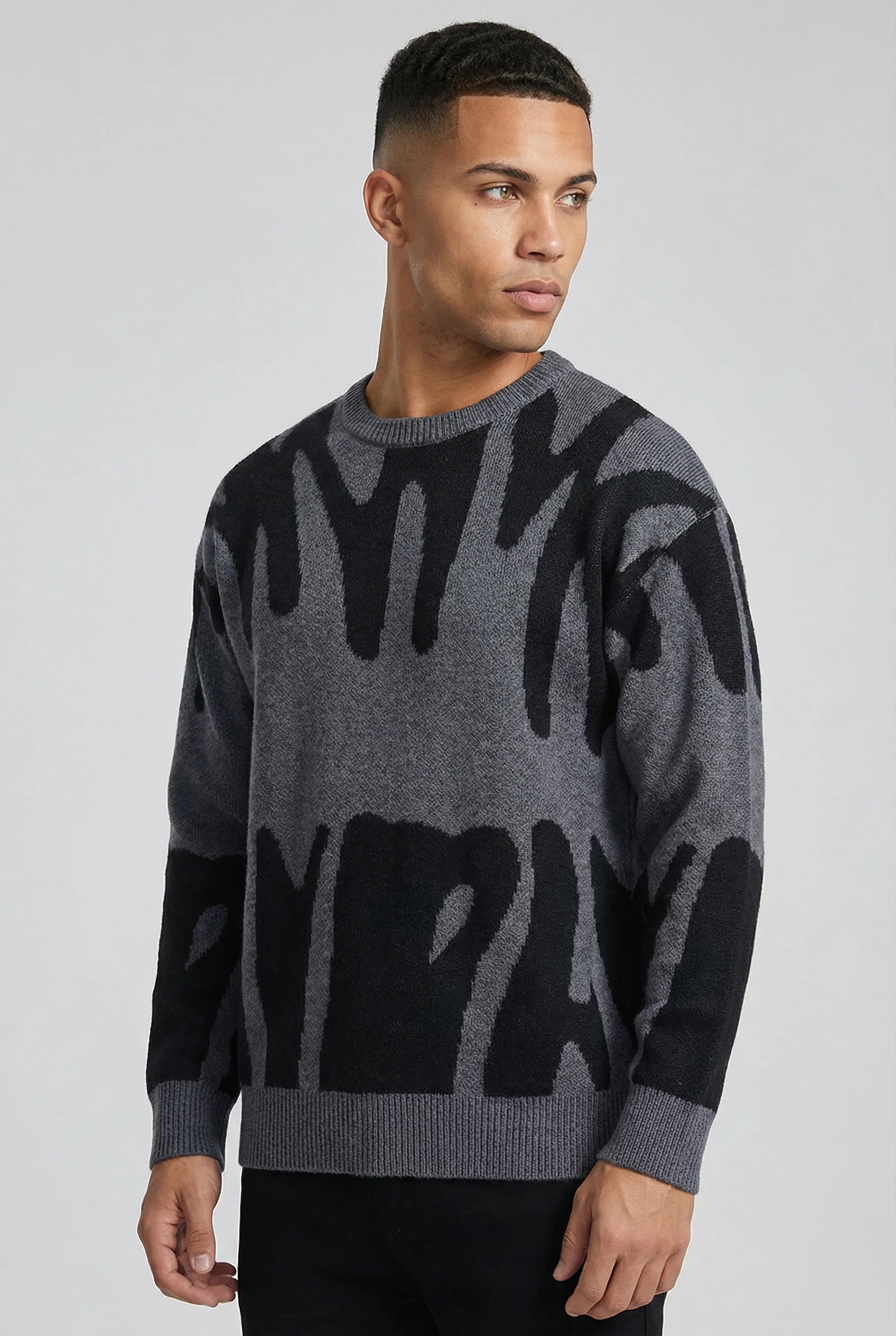 Grey abstract jacquard knit crew neck jumper for men by Ilynora London, side view with modern relaxed fit