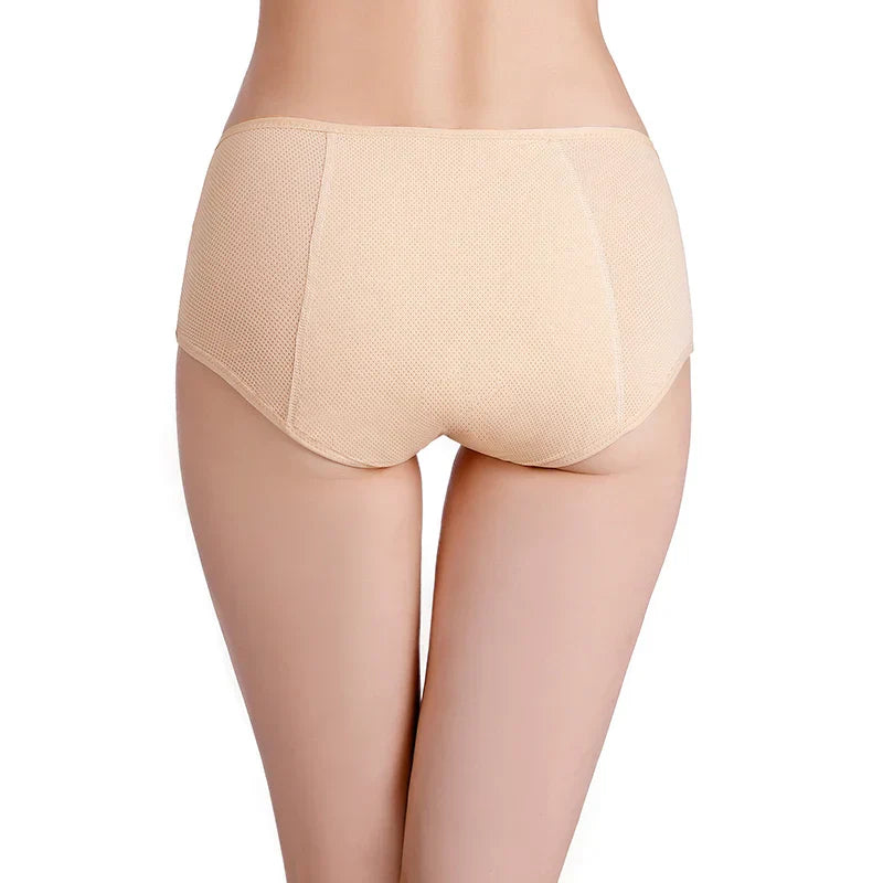 Woman wearing ILYNORA beige high waist period briefs shown from the back