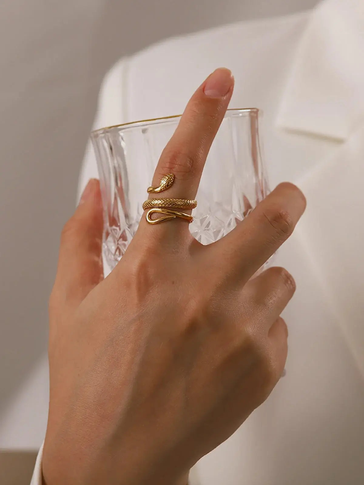 Adjustable snake ring in gold tone by Ilynora, worn view highlighting wrap-around design and elegant silhouette