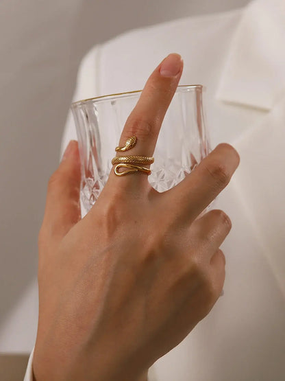 Adjustable snake ring in gold tone by Ilynora, worn view highlighting wrap-around design and elegant silhouette