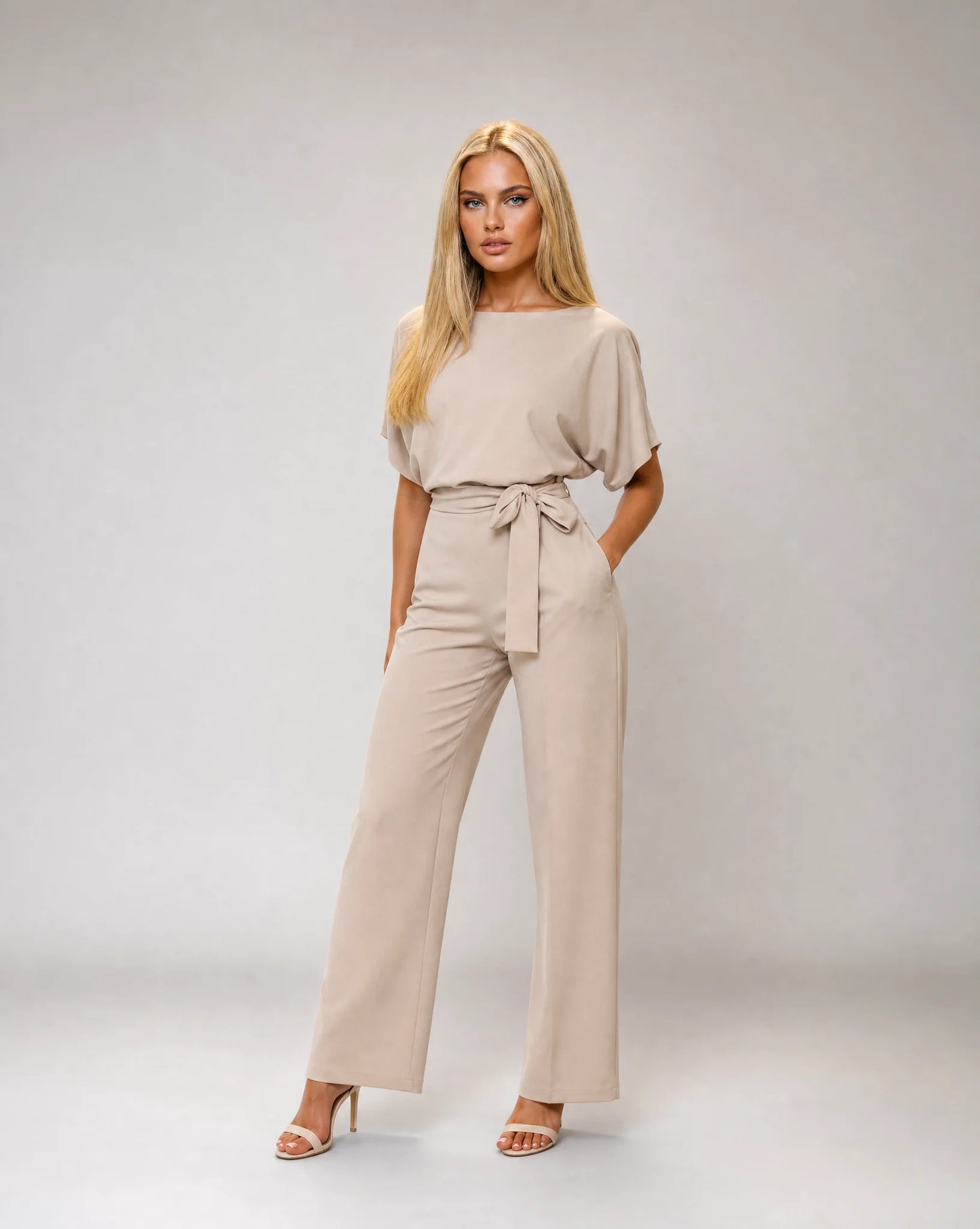 Apricot belted wide leg jumpsuit for women by Ilynora, front view with elegant draping and relaxed fit