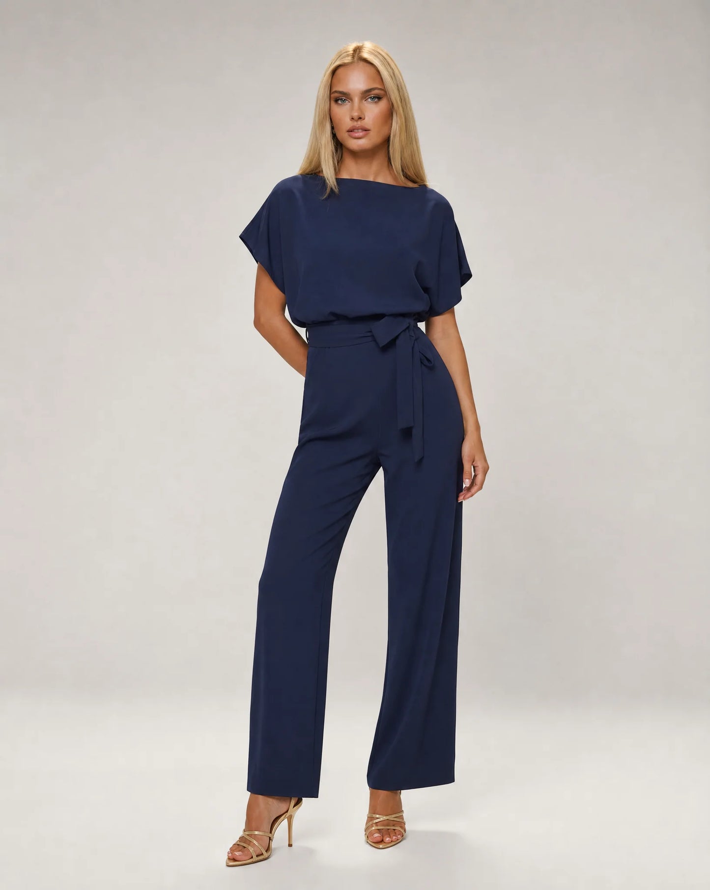 Navy belted wide leg jumpsuit for women by Ilynora, front view with draped sleeves and elegant fit