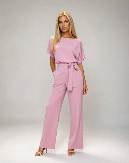 Pink belted wide leg jumpsuit for women by Ilynora, front view with flowing fit and elegant waist detail