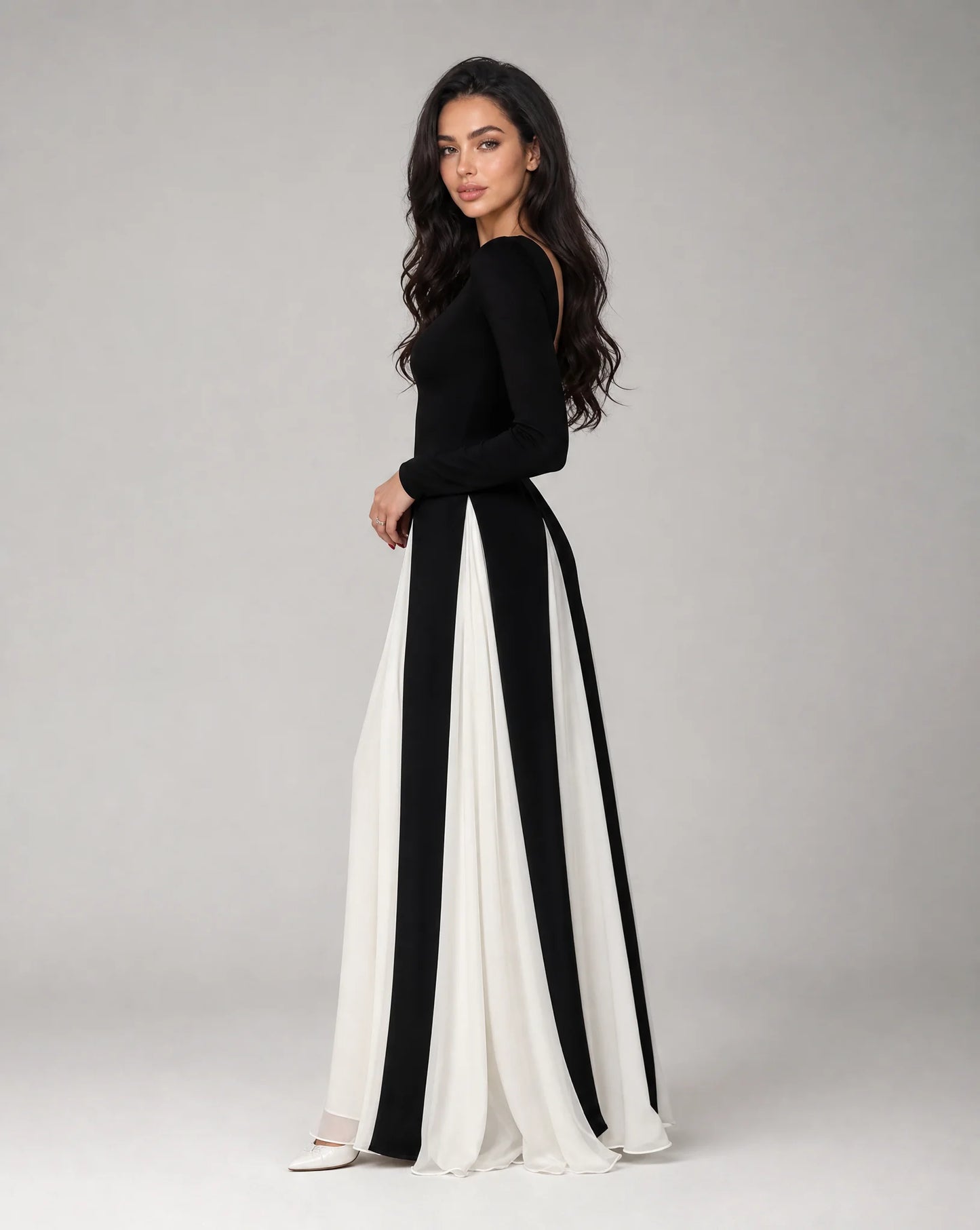 Full-length women's black and white contrast panel maxi dress featuring a fitted bodice, flowing skirt and timeless evening elegance by ILYNORA