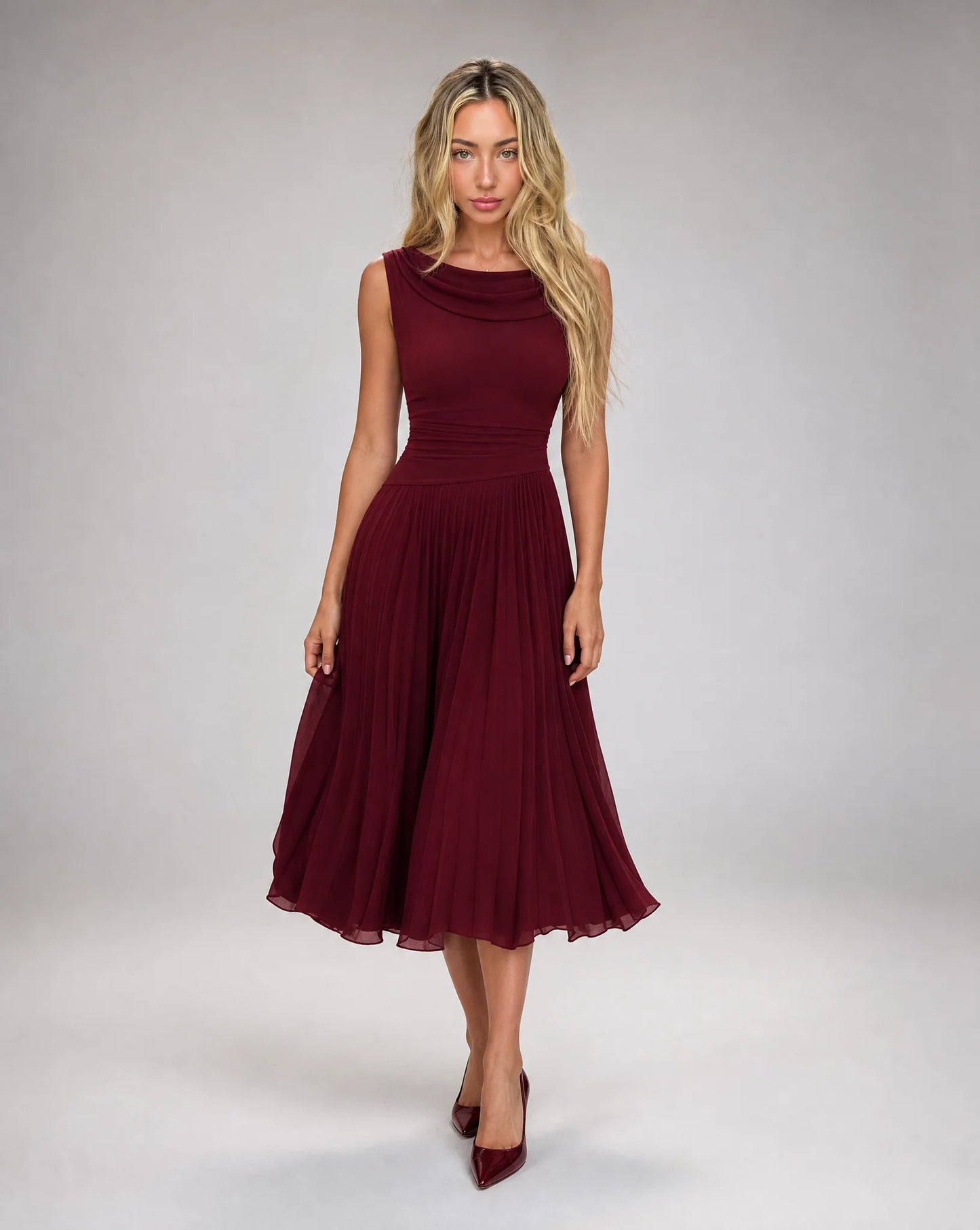 Women's burgundy draped cowl neck pleated midi dress with elegant sleeveless bodice and flowing pleated skirt by ILYNORA