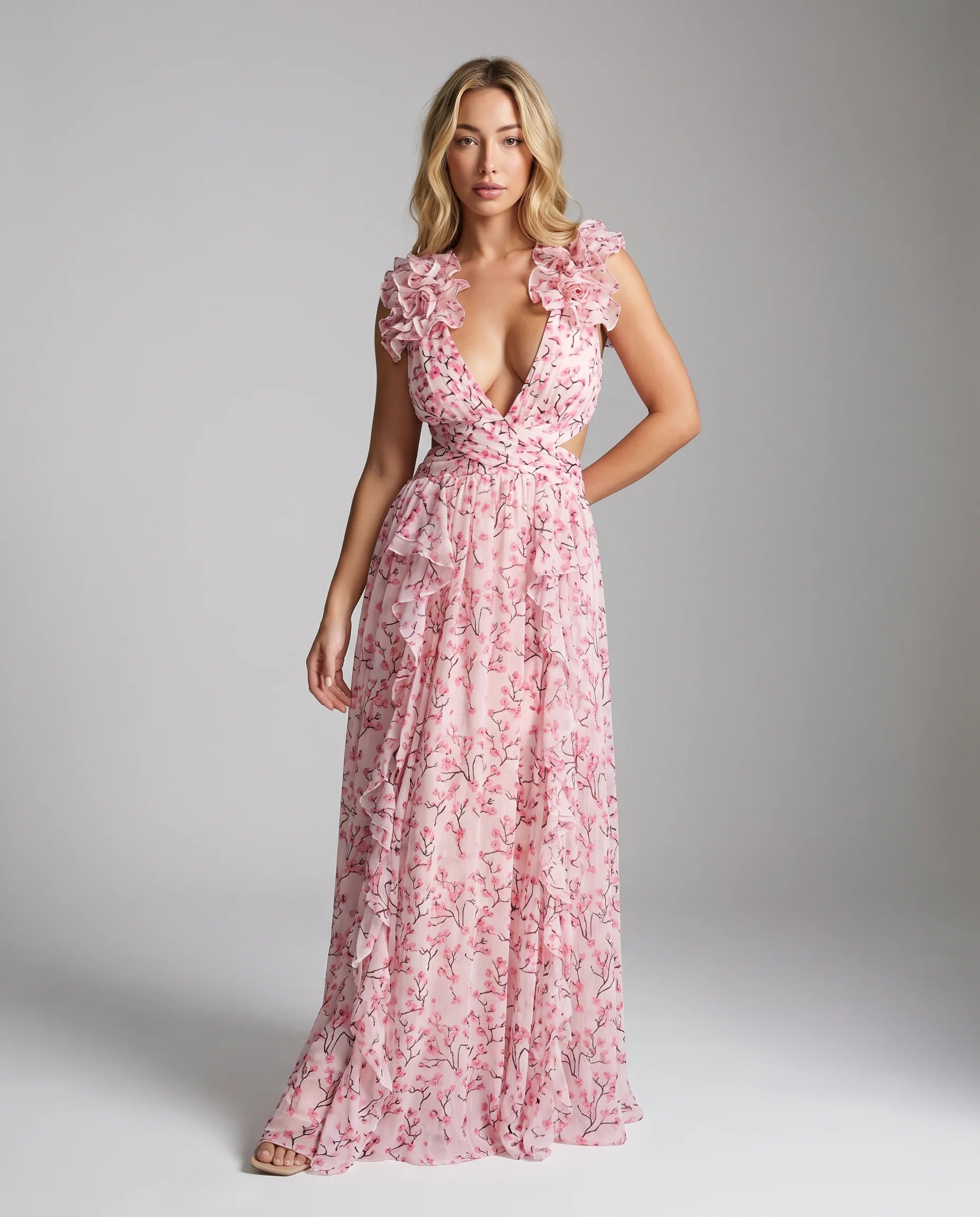 Pink floral ruffle cut out maxi dress for women by Ilynora, full length view with flowing skirt and cut out detail