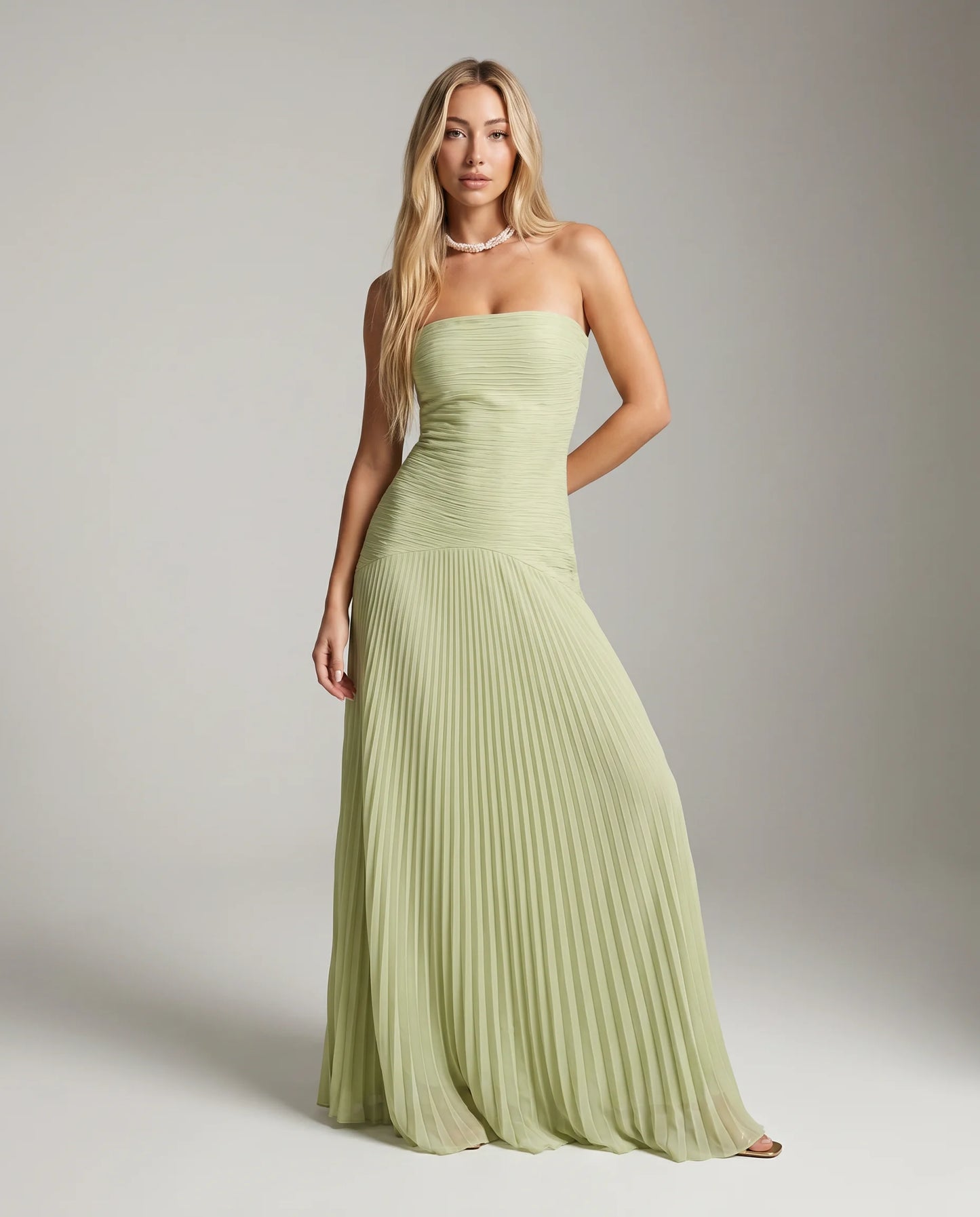 Green strapless pleated maxi dress for women by Ilynora, full length view with airy pleated skirt