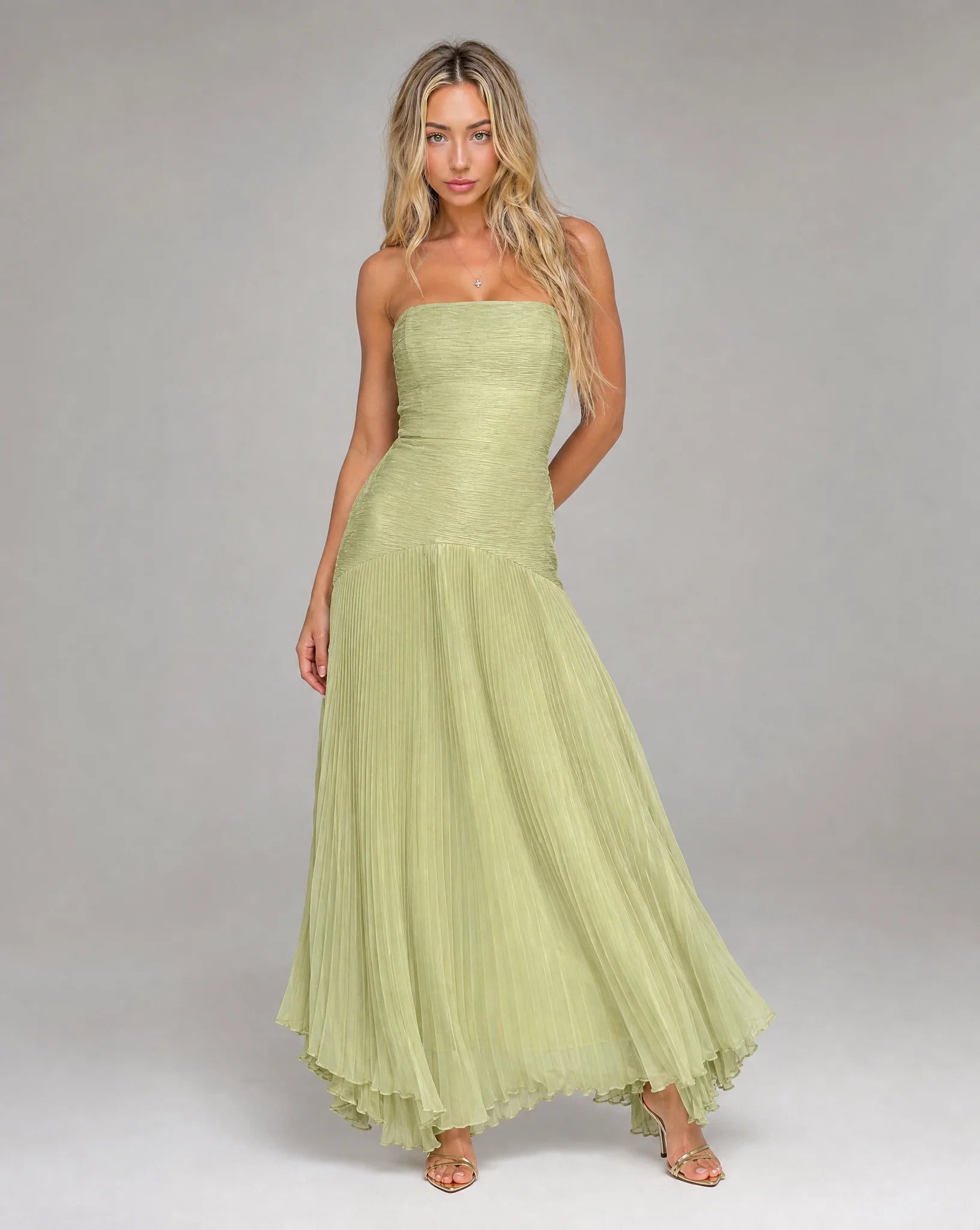 Green strapless pleated maxi dress for women by Ilynora, side view with graceful movement and soft texture