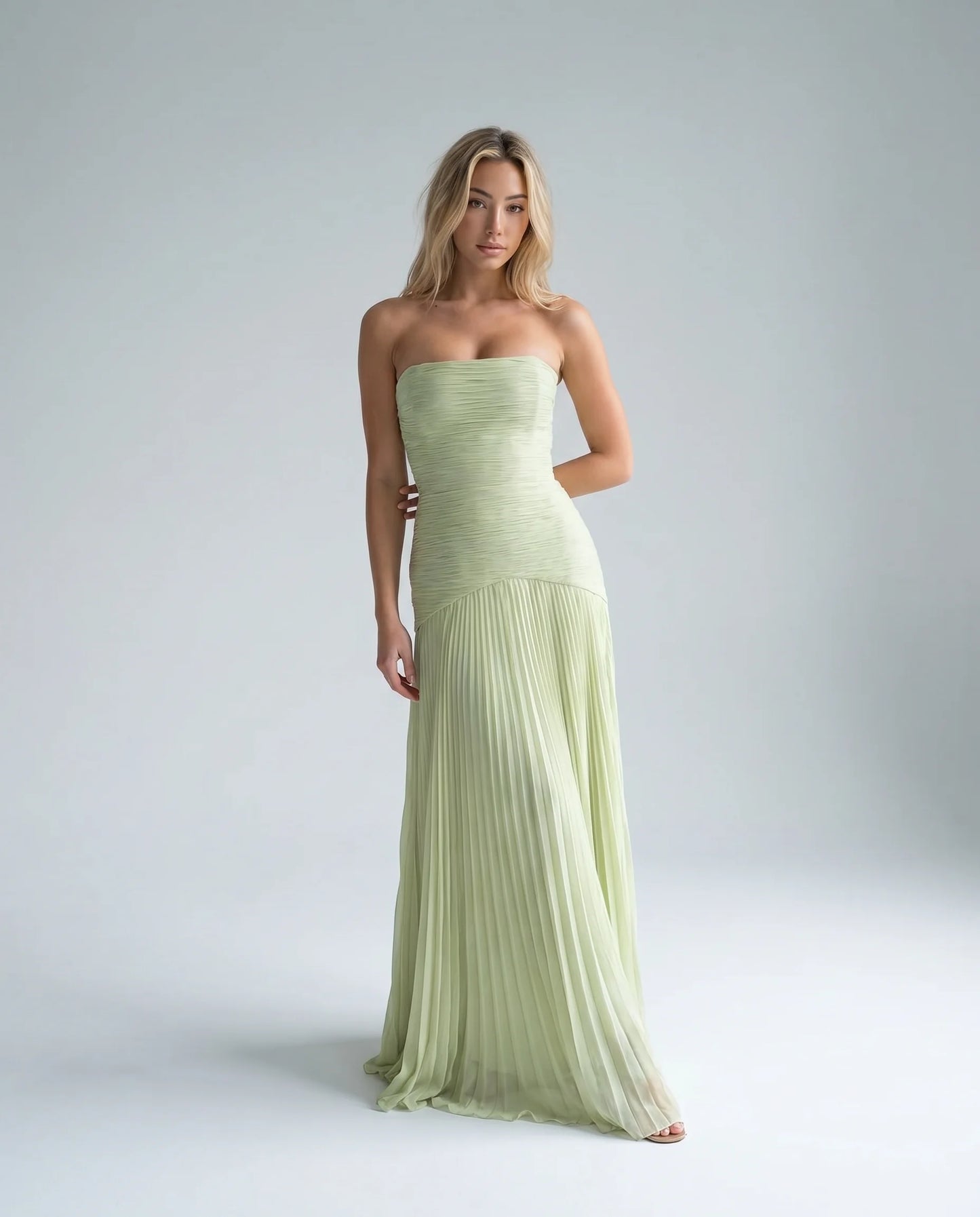 Green strapless pleated maxi dress for women by Ilynora, front view with flowing silhouette and elegant draping