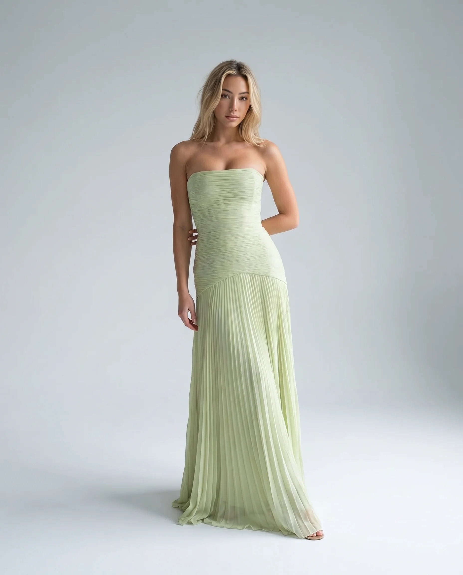 Green strapless pleated maxi dress for women by Ilynora, front view with flowing silhouette and elegant draping