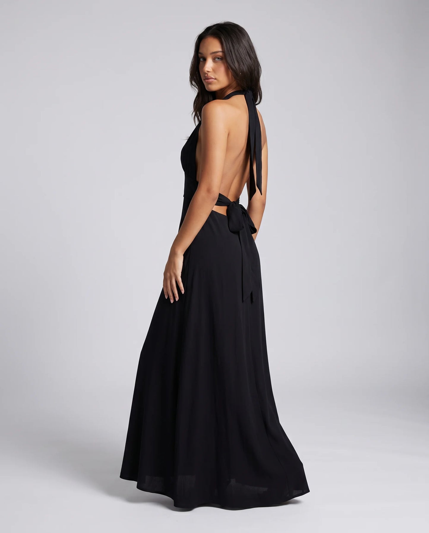 Black halter neck split maxi dress for women by Ilynora, back view showcasing the open back design