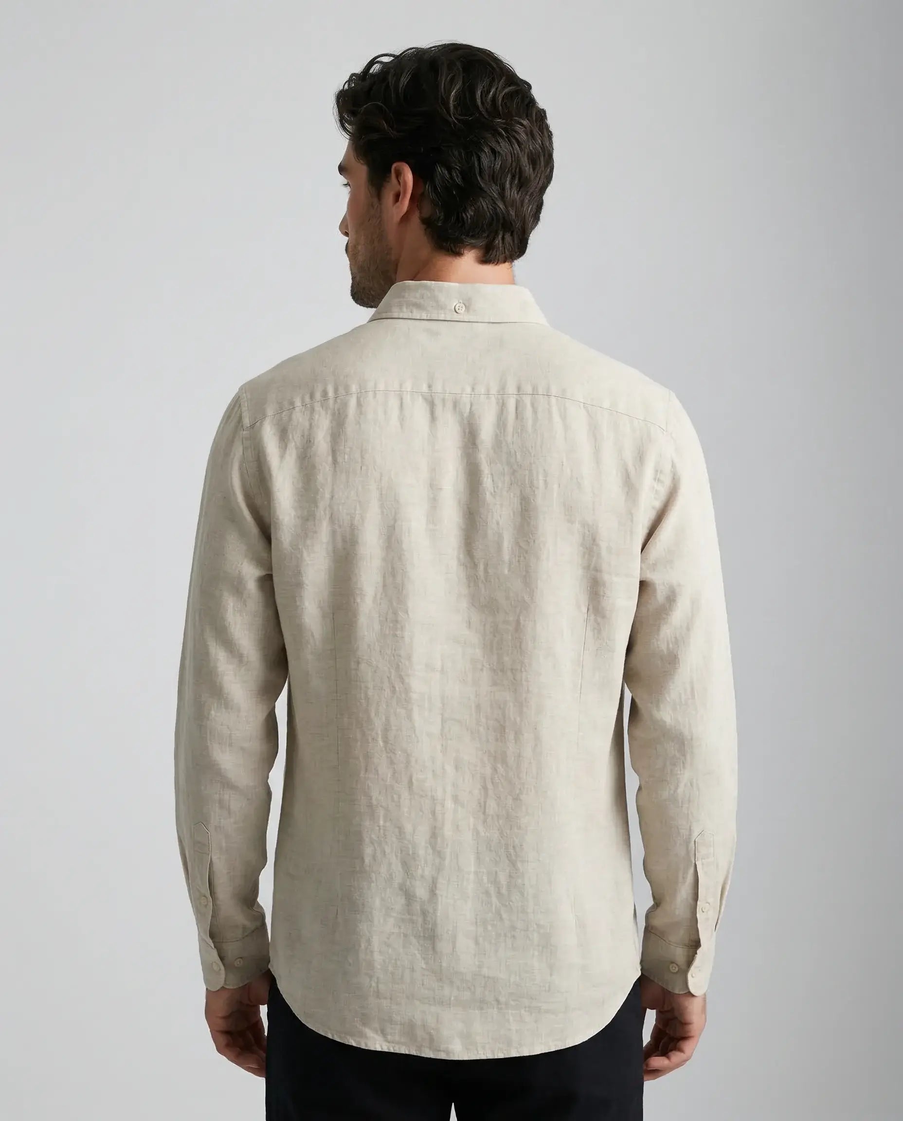 Beige linen resort shirt by Ilynora, back view highlighting lightweight texture and clean silhouette