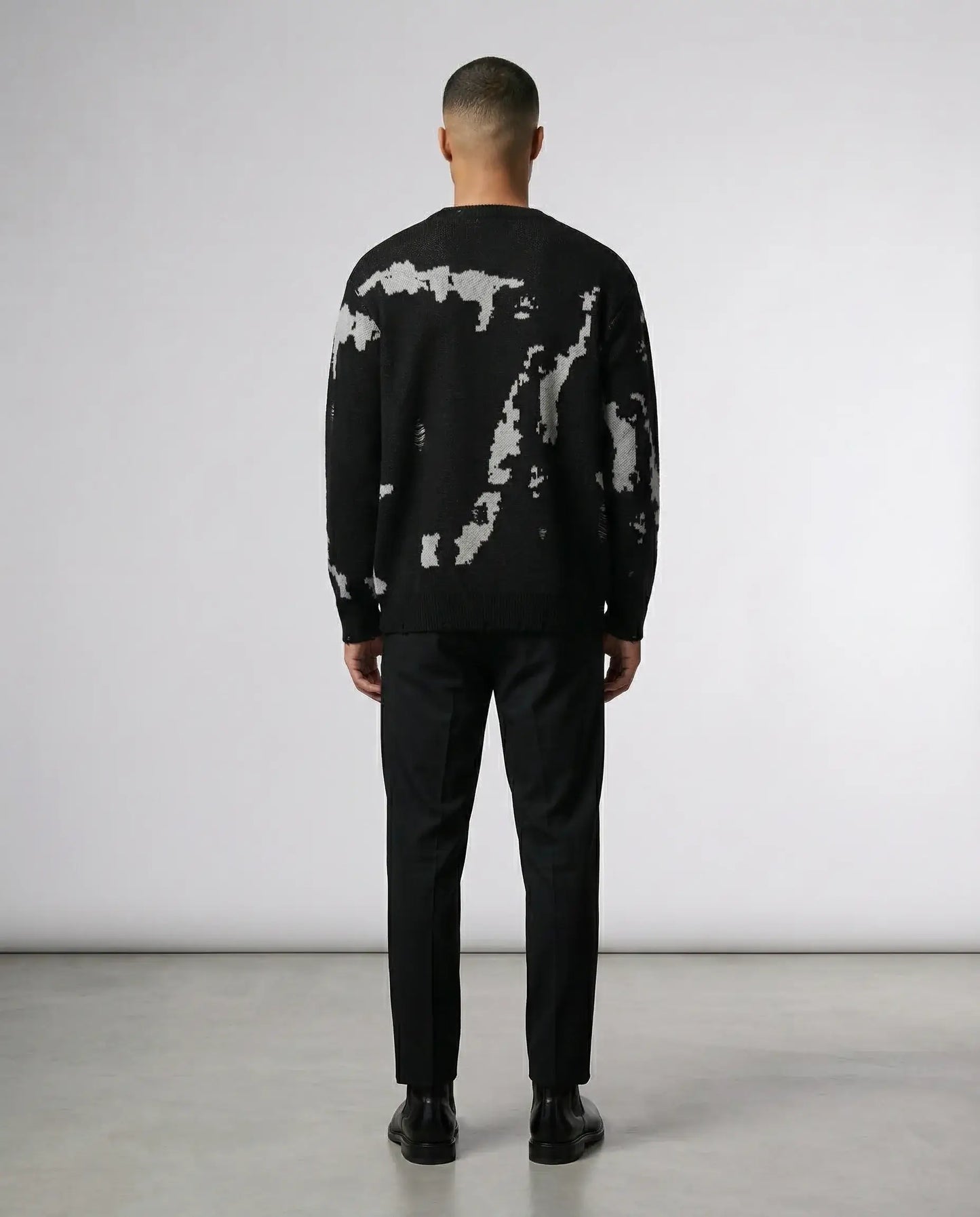 Black abstract knit sweater by Ilynora, back view highlighting artistic pattern and clean silhouette