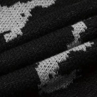 Men's black abstract knit sweater by Ilynora, sleeve detail showing pattern and ribbed cuff