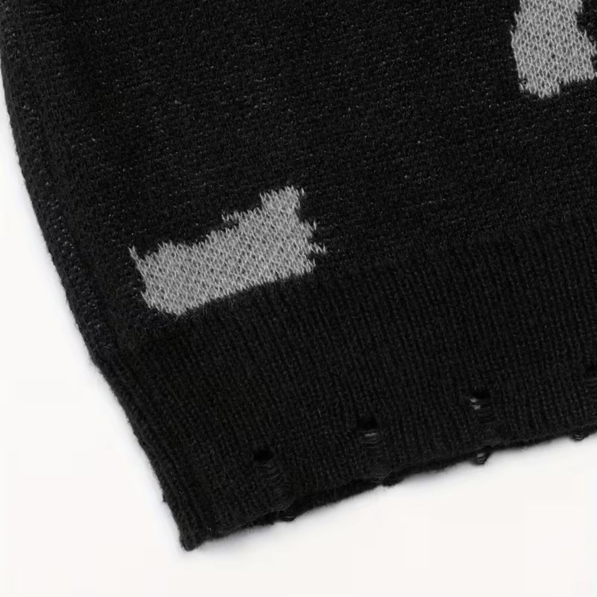 Black crewneck knit sweater by Ilynora, fabric close-up highlighting pattern and soft texture