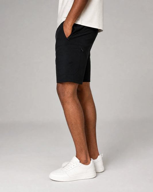 Men's black technical training shorts with lightweight stretch fabric, tapered fit and side profile by ILYNORA
