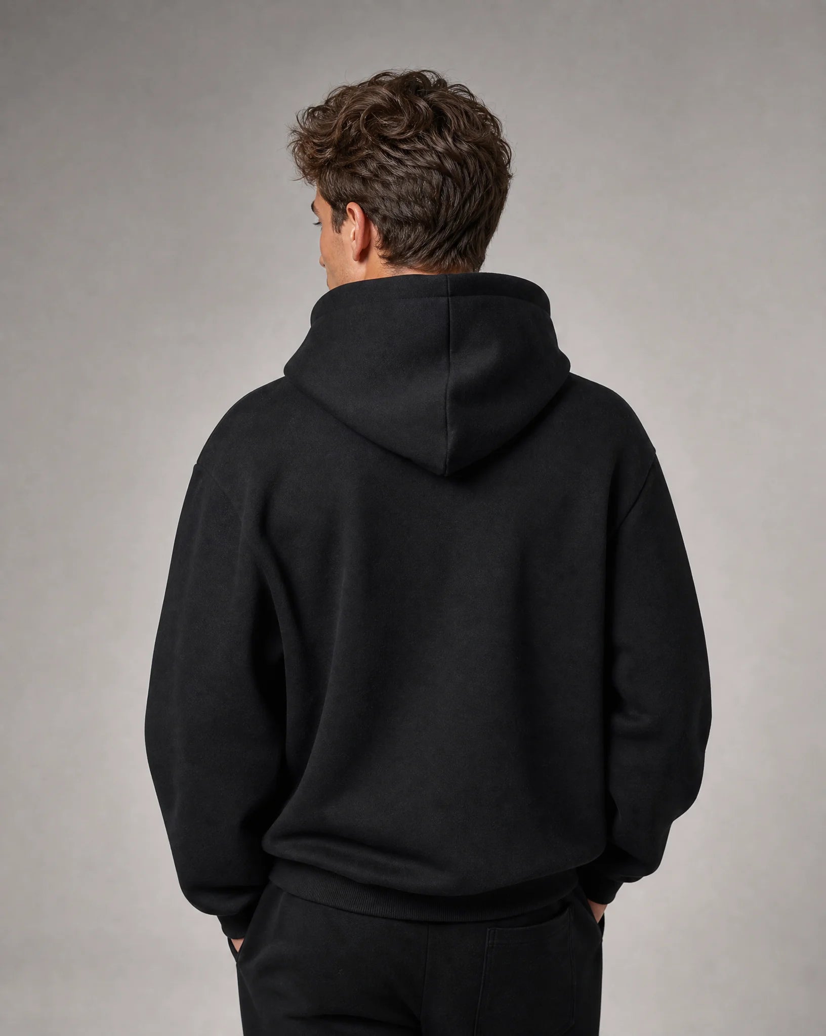 Men's black relaxed fit hoodie with soft brushed fleece, crossover hood and back view by ILYNORA