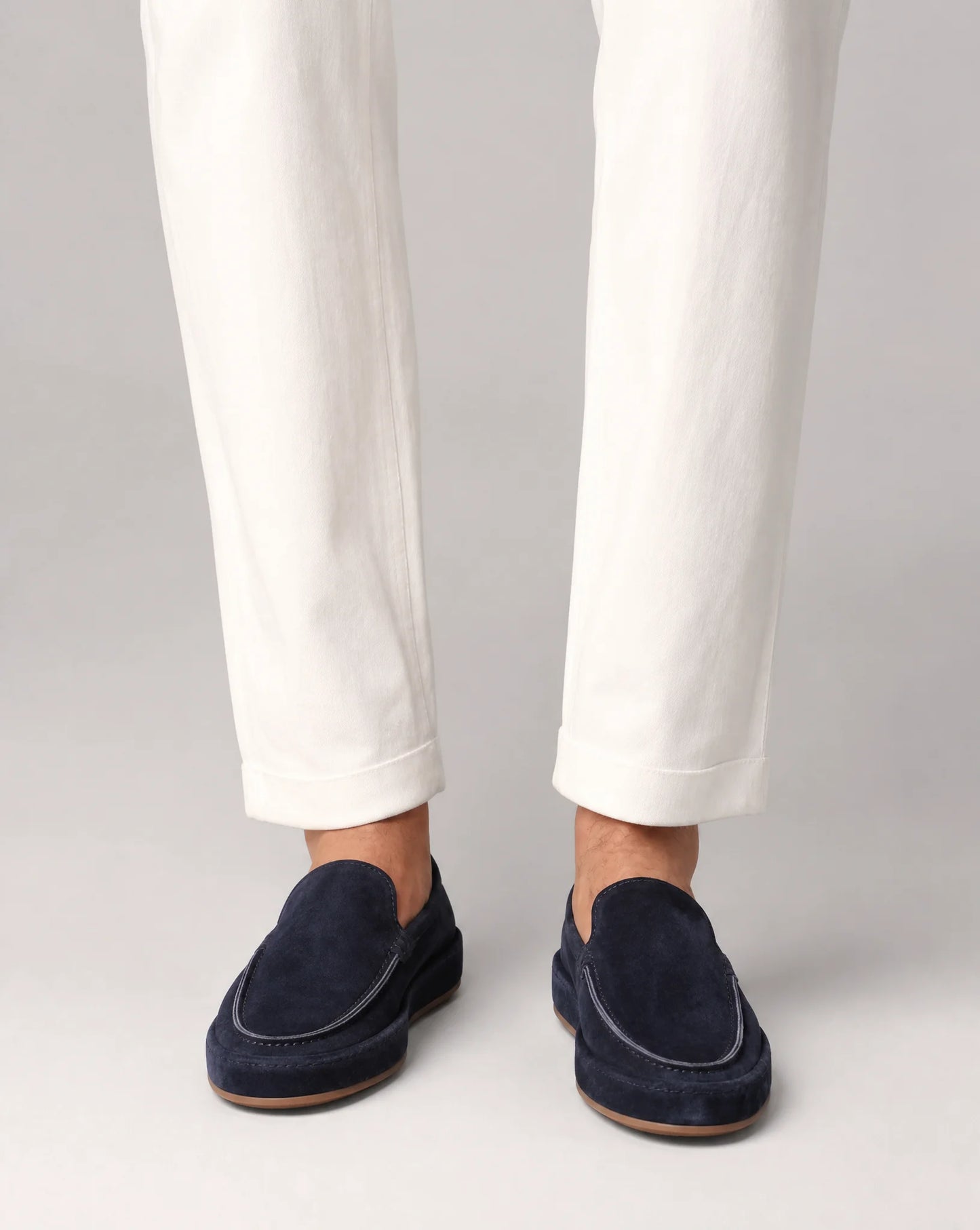 Men's navy suede loafers styled with tailored trousers for a polished smart casual look by ILYNORA