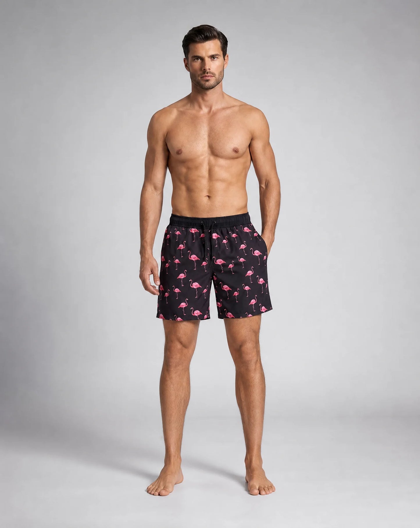 Men's black flamingo compression lined swim shorts with vibrant tropical pattern by ILYNORA