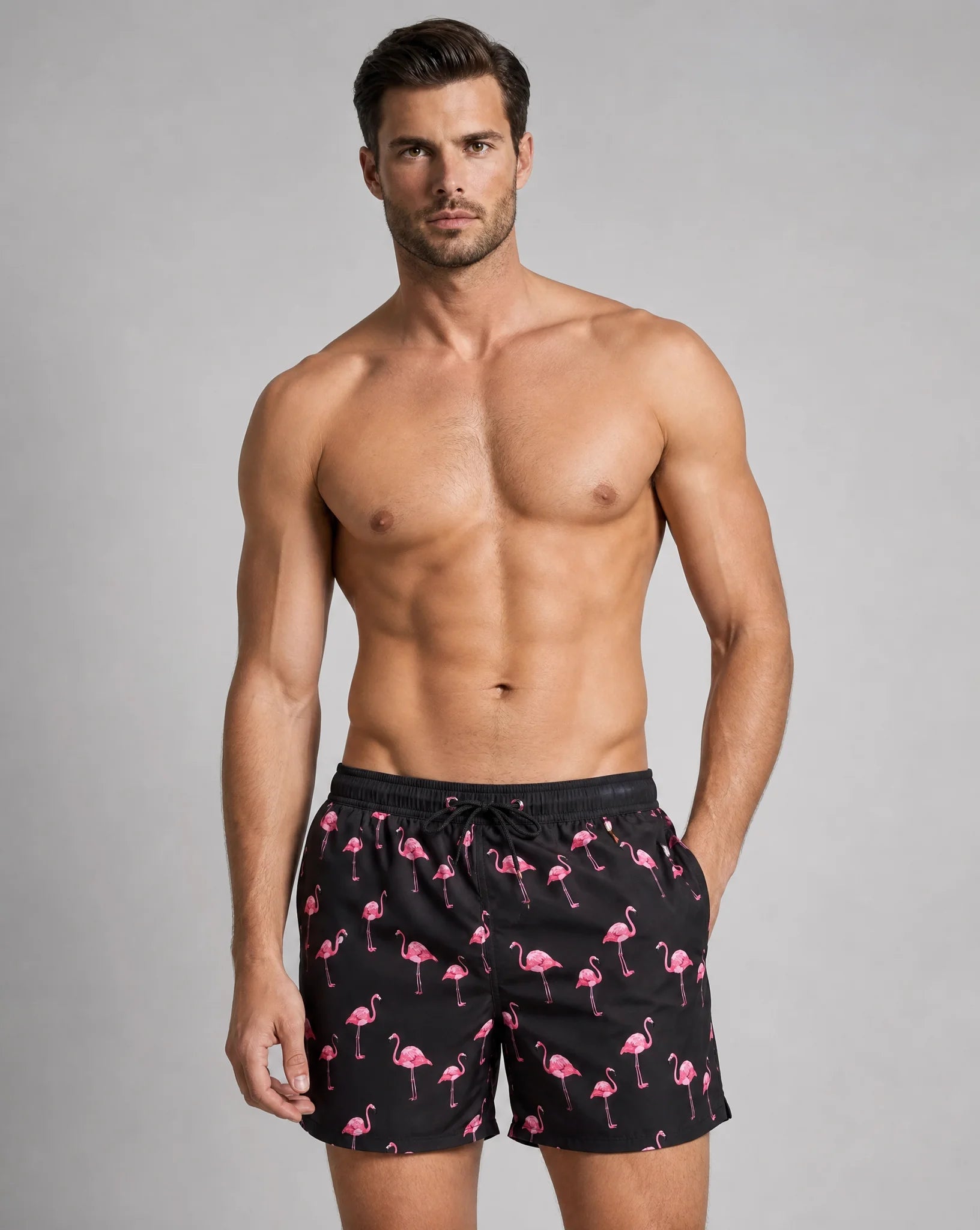 Men's black flamingo swim shorts with supportive liner and tropical summer print by ILYNORA