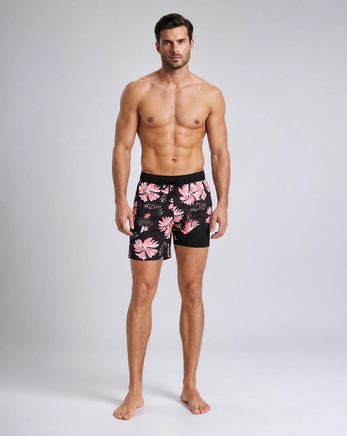 Men's black orange tropical swim shorts with compression liner and bold print by ILYNORA