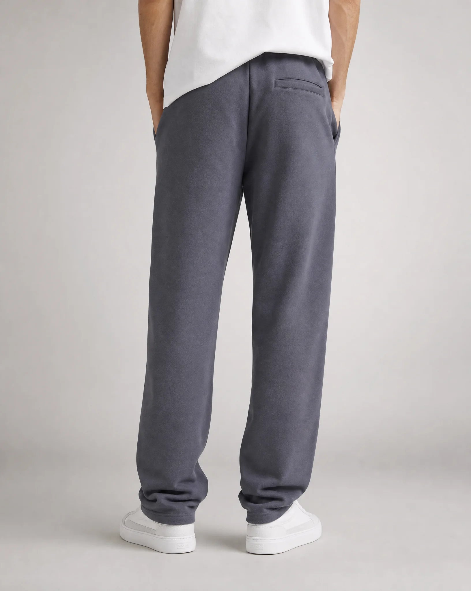 Men's dark grey relaxed fit open hem joggers with back welt pocket, premium fleece fabric and rear view by ILYNORA