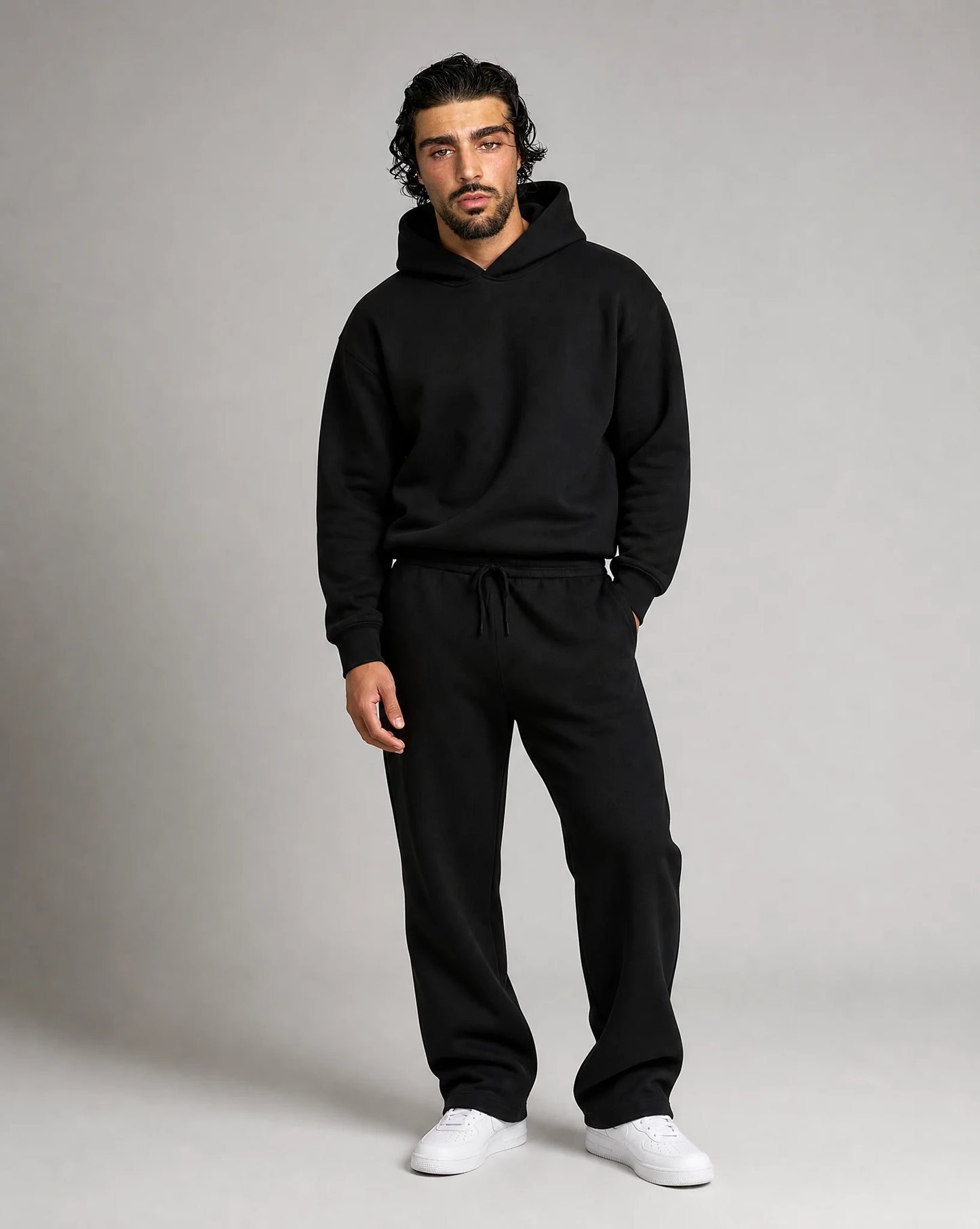 Black oversized hoodie and jogger set for men by Ilynora, front view with modern streetwear style