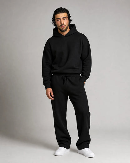 Black oversized hoodie and jogger set for men by Ilynora, front view with modern streetwear style