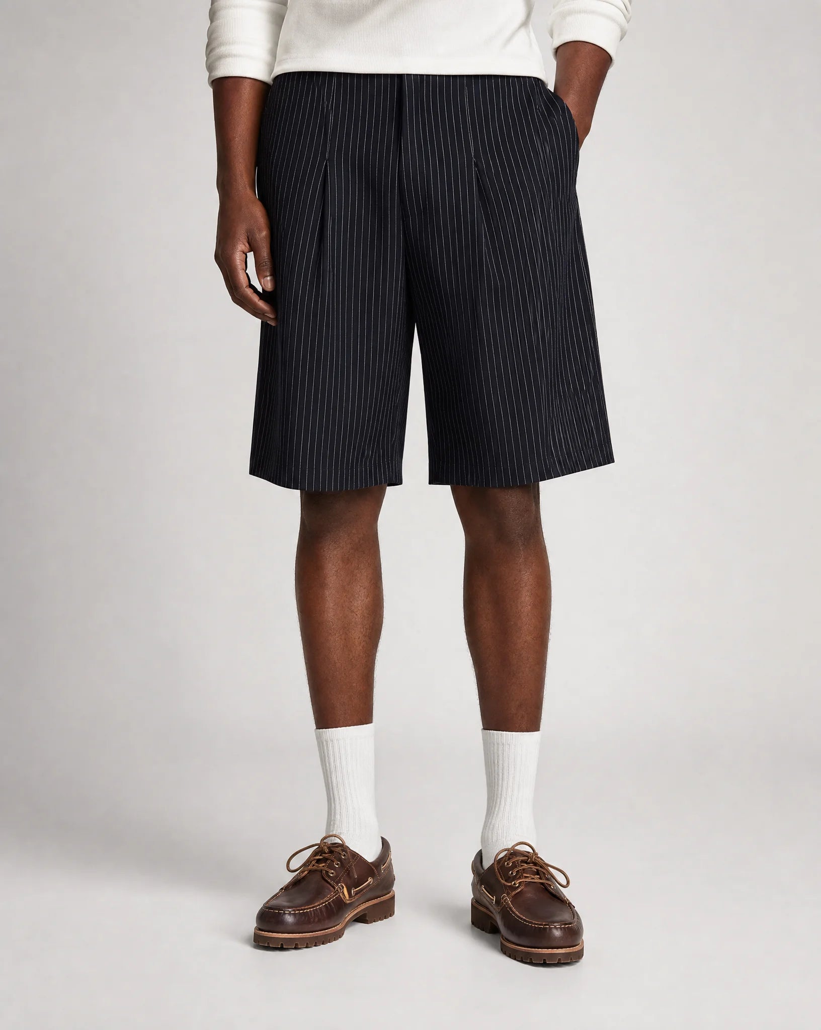 Men's navy pinstriped bermuda shorts with relaxed baggy fit, front pleats and adjustable waist by ILYNORA