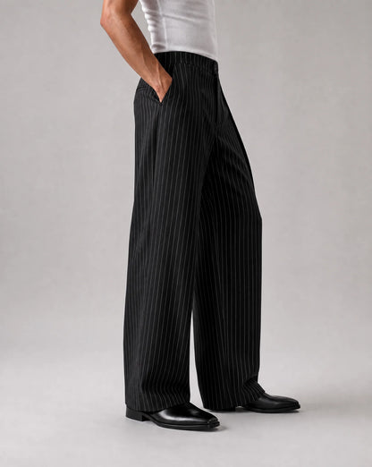 Men's black wide leg pinstripe pants with flowing fit and refined tailored finish by ILYNORA