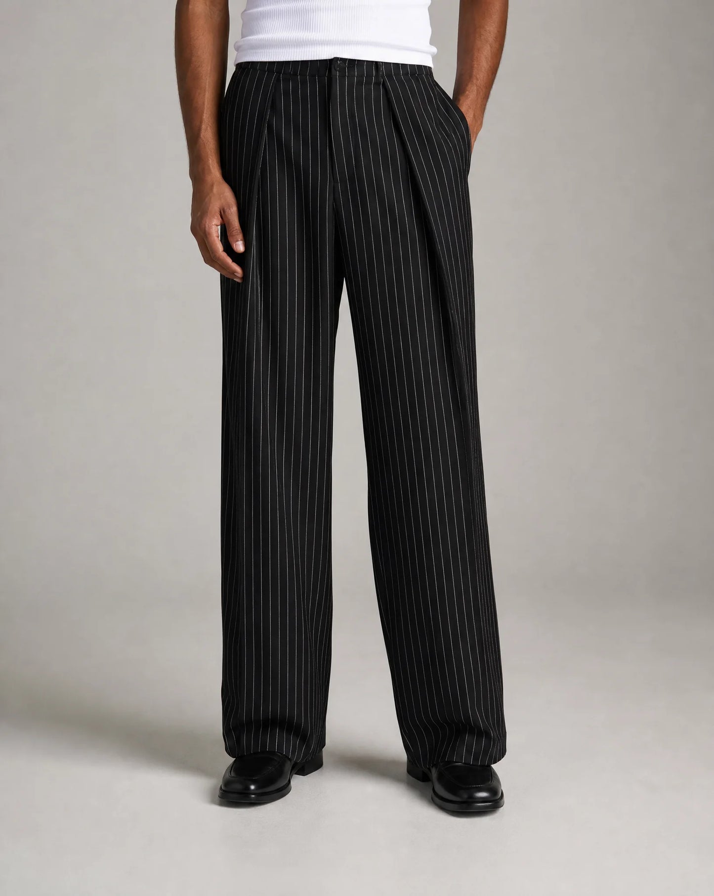 Men's black pinstripe wide leg trousers with relaxed tailored fit and modern silhouette by ILYNORA