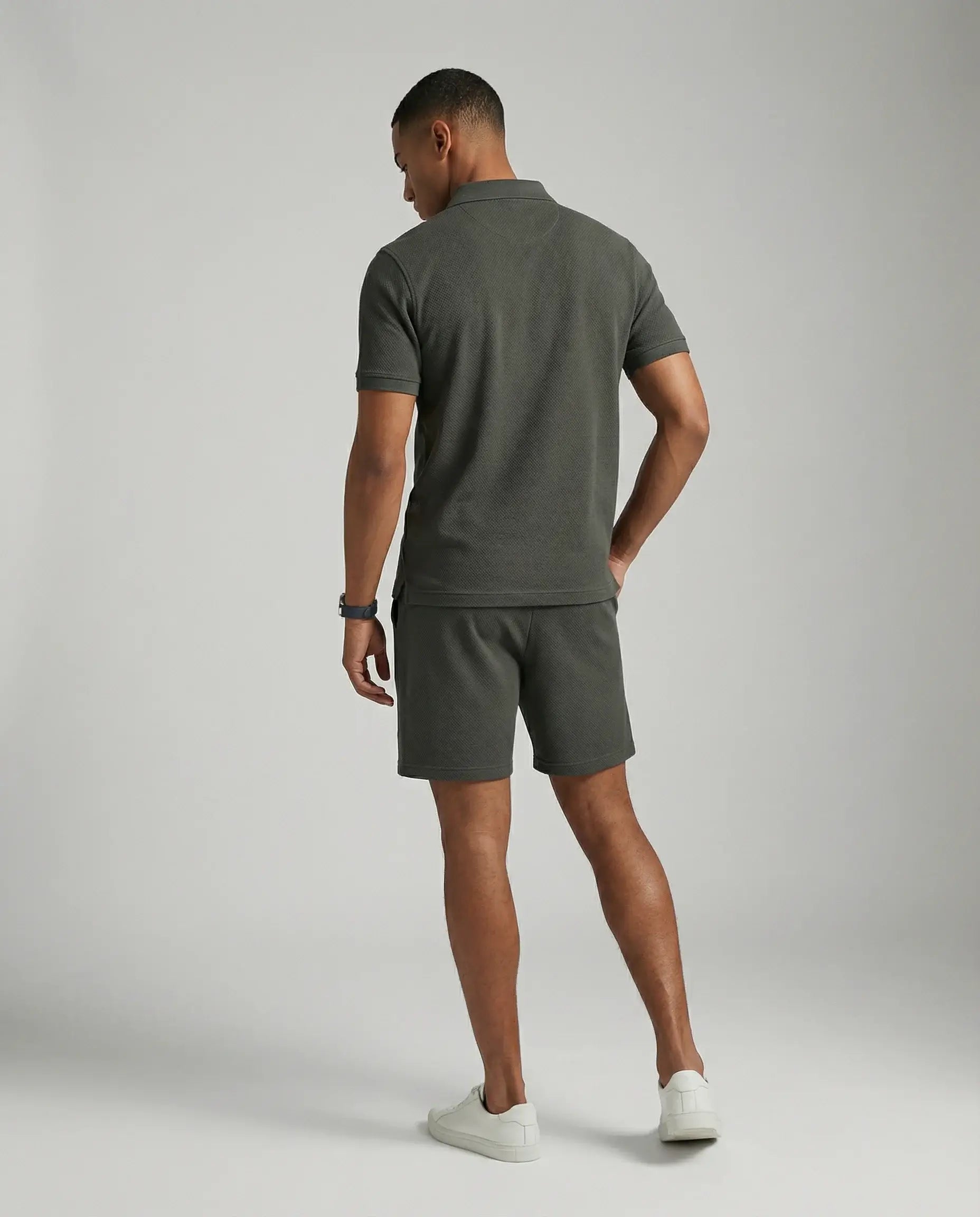 Dark grey polo and shorts set by Ilynora, back view highlighting tailored fit and breathable fabric
