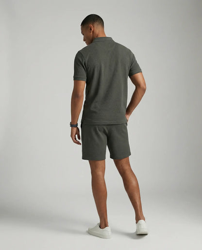 Dark grey polo and shorts set by Ilynora, back view highlighting tailored fit and breathable fabric