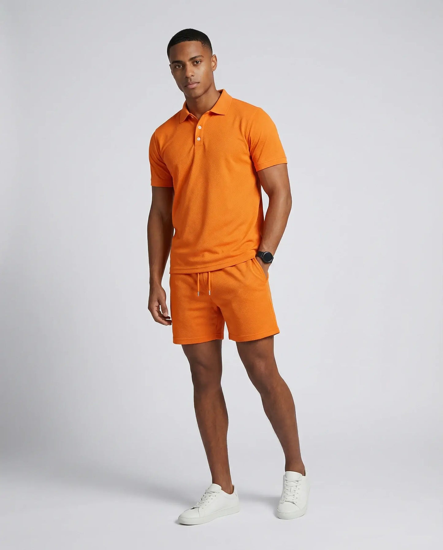 Men's polo shirt and shorts set in orange by Ilynora, front view with bold color and modern summer fit