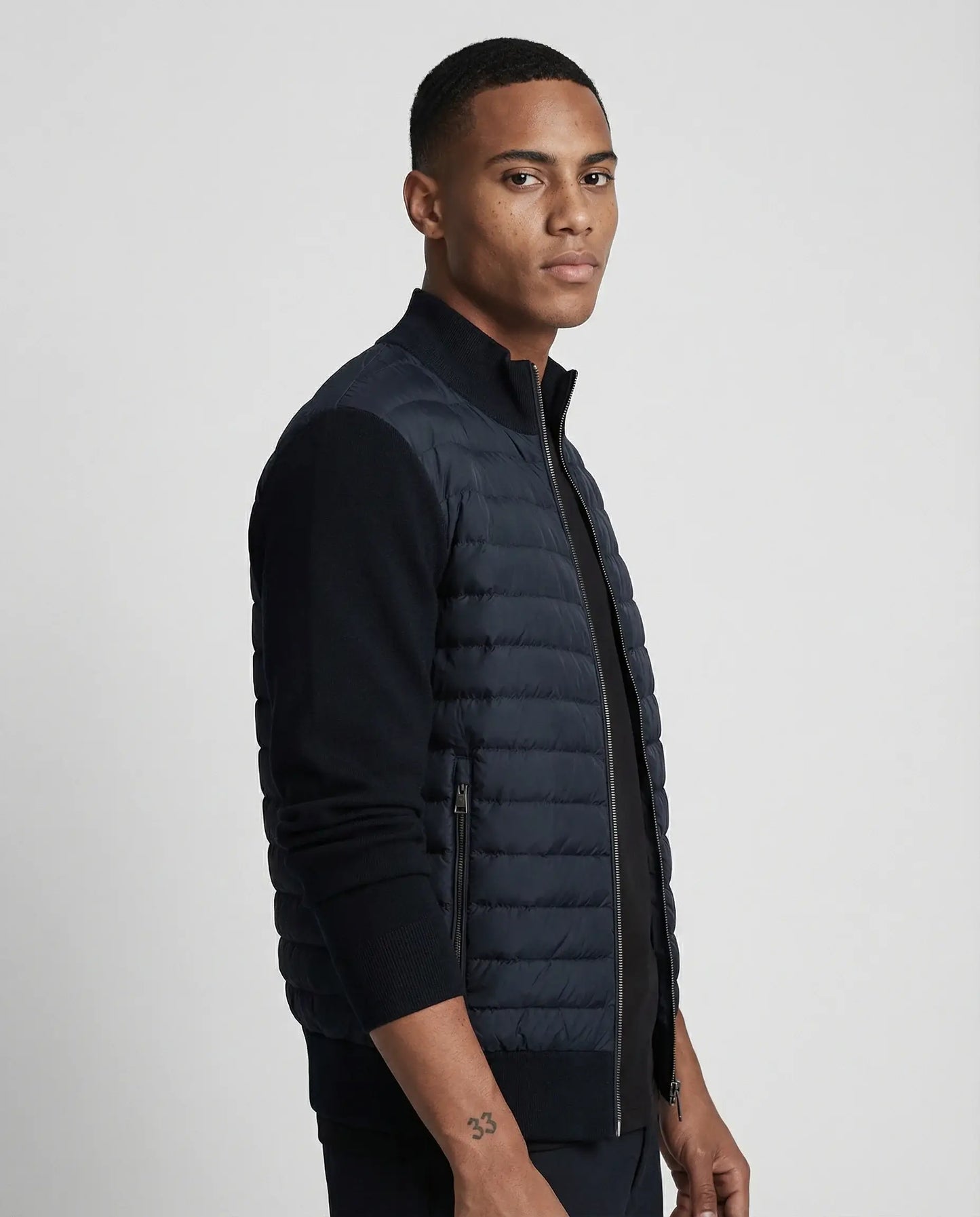 Navy quilted knit bomber jacket by Ilynora, side view highlighting structured fit and lightweight design