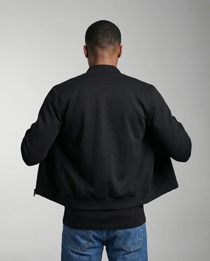 Navy blue bomber jacket by Ilynora, back view showing quilted texture and ribbed trims