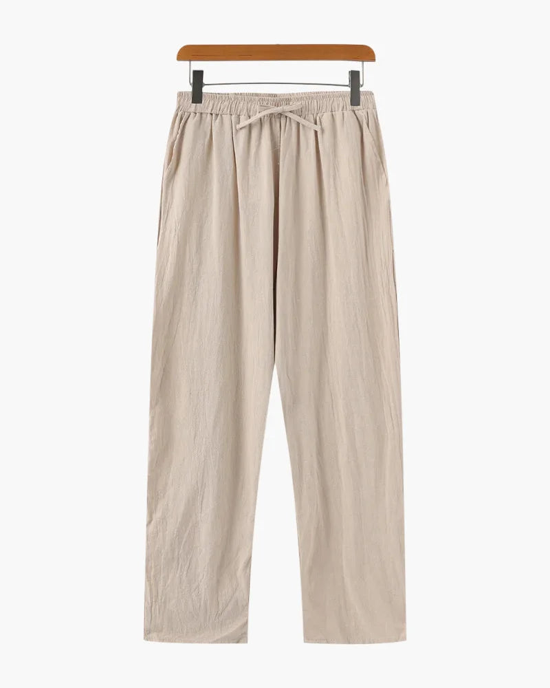 Relaxed linen trousers in beige by Ilynora, close-up showing drawstring waist and soft texture