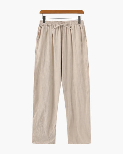 Relaxed linen trousers in beige by Ilynora, close-up showing drawstring waist and soft texture